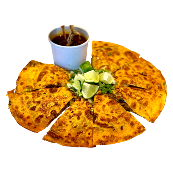 Birria pizza sliced into wedges with avocado and consomme