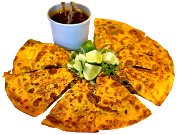 Birria pizza sliced into wedges with avocado and consomme