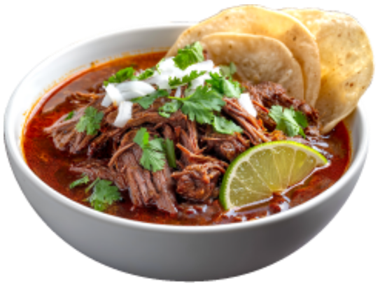 Bowl of red pozole with shredded meat, lime and tostadas